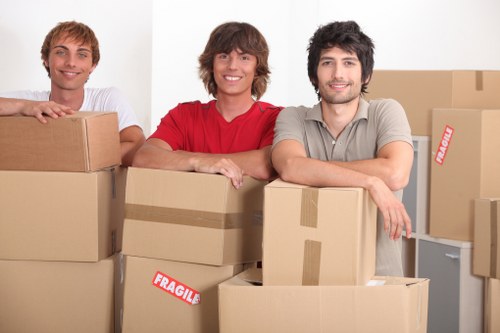 Local movers handling furniture in a Hornchurch residential street